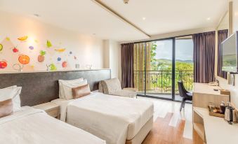 a hotel room with two beds , one on each side of the room , and a balcony overlooking a beautiful view at Sand Dunes Chaolao Beach Resort