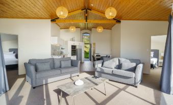 a modern living room with two couches , one on the left and one on the right side of the room at Castaways Resort
