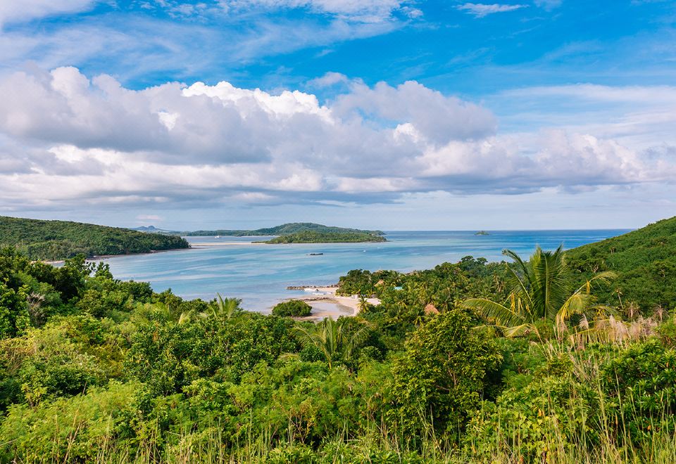 a beautiful view of a tropical island with lush green vegetation and the ocean in the background at Navutu Stars Resort