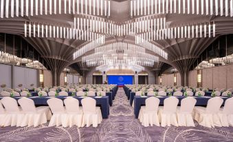 A spacious ballroom is arranged with rows of chairs for an event at the hotel at Grand Mercure Hangzhou Zijingang