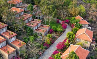 an aerial view of a residential area with multiple houses surrounded by greenery and flowers at Victoria Nui Sam Lodge