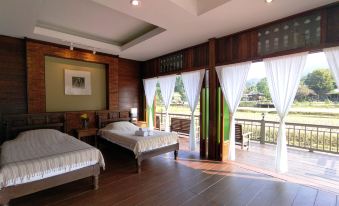 a bedroom with two beds , one on the left and one on the right side of the room at Lhongkhao Samoeng by Chi Villa