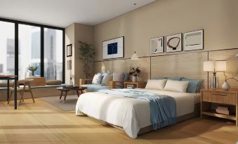 a spacious bedroom with hardwood floors , a large bed , and a window overlooking a beautiful view at Z Hotel