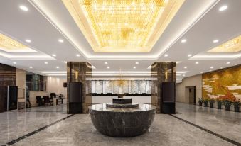 The hotel features a spacious marble reception area with several seating areas and hanging lights above the front entrance at Shanghai Shaanxi Business Hotel