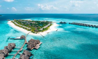 aerial view of a tropical island with white sandy beaches , clear blue water , and lush greenery at Heritance Aarah-Premium All Inclusive
