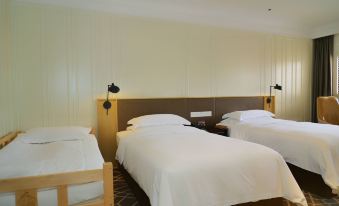 The second bedroom features two white beds and a wood-paneled accent wall at Metropolo Jinjiang Hotel Classiq (Shanghai Nanjing Road Pedestrian Street)