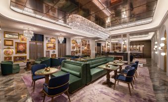 The restaurant features tables and chairs in the center, accompanied by an ornate ceiling at Grand Mercure Hangzhou Zijingang