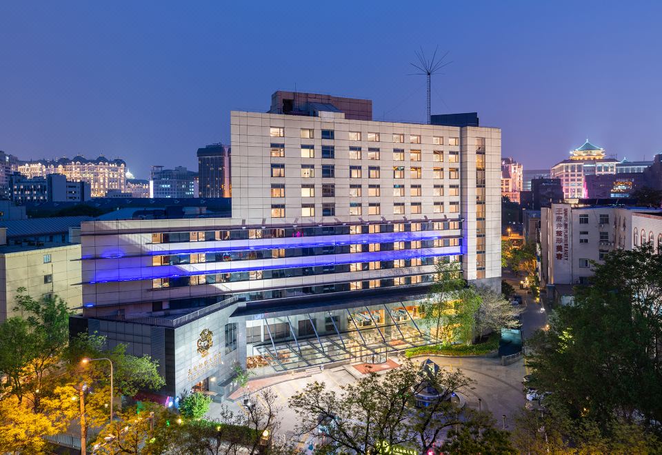 A well-lit urban setting is characterized by a large building in the center at Sunworld Hotel