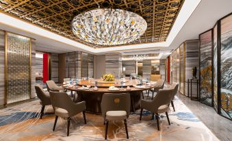 dining, featuring an oval table and chairs in the center at China Hotel