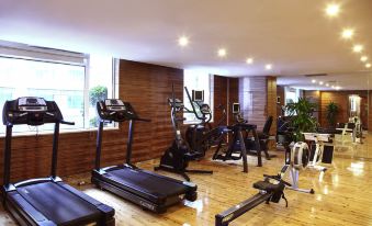 The gym is equipped with multiple treadmills and ellipticals positioned in front of large windows at Novotel Guangzhou Baiyun Airport (Terminal)