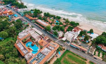 aerial view of a beachfront resort with a swimming pool surrounded by buildings and palm trees at Kacha Resort & Spa, Koh Chang