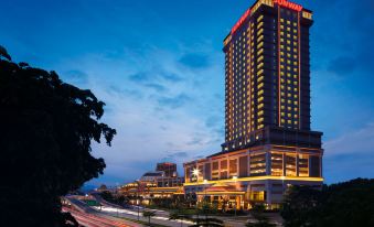 "a modern hotel building with the name "" hyatt "" lit up at night , surrounded by cars and trees" at Sunway Lagoon Hotel , Formerly Sunway Clio Hotel