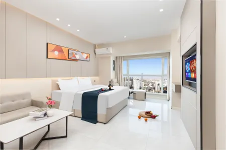 Qiyue Qingya Apartment Hotel (Longkou Boshang Shopping Plaza) Отели рядом со станцией Longkoushi Railway Station