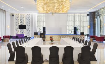 a large conference room with multiple chairs arranged in rows and a chandelier hanging from the ceiling at Pickalbatros White Beach Taghazout - Adults Friendly 16 Years Plus - Ultra All Inclusive