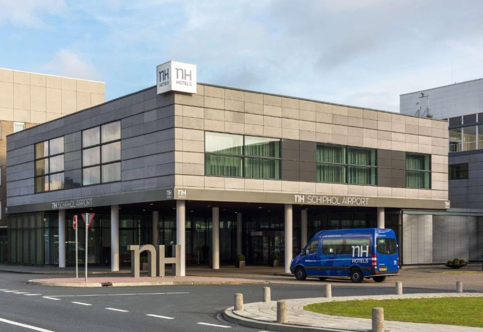 a building with a large glass window and the number 7 1 4 is shown in the image at NH Amsterdam Schiphol Airport