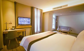 The bedroom features a double bed, a large window, and a flat-screen TV mounted on the wall at Homeinn Selected Hotel (Shanghai Wuning Road Subway Station Anyuan Road)