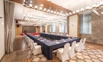 a venue prepared for events or functions, featuring spacious rooms with long tables and chairs at Jinfan Wanyuan Hotel