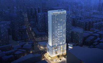A rendering depicts the construction of a new hotel adjacent to an office building during nighttime, alongside other structures at Mercure Guangzhou Beijing Road Pedestrian Street Hotel
