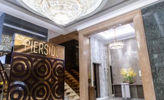 The hotel entrance features a grand chandelier and a wood-paneled entryway at The Royal Pacific Hotel and Towers