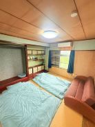 Kikai Island Rakuraku Stay “Room 201” – Retro island life in a tropical nostalgic apartment.