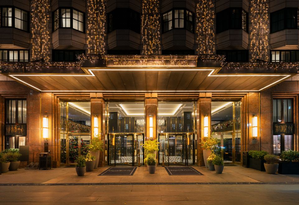 the entrance to a building with large glass doors and a sign above the door at Hilton Vienna Plaza