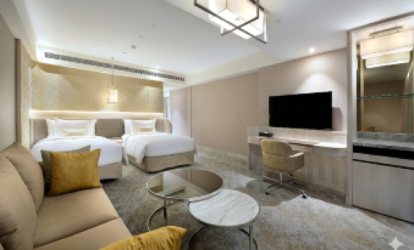a modern hotel room with a large bed , couch , desk , and tv . also a dining table in the room at Caesar Park Hotel Banqiao