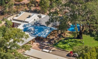 a bird 's eye view of a building with a large tree and a swimming pool at Wilpena Pound Resort