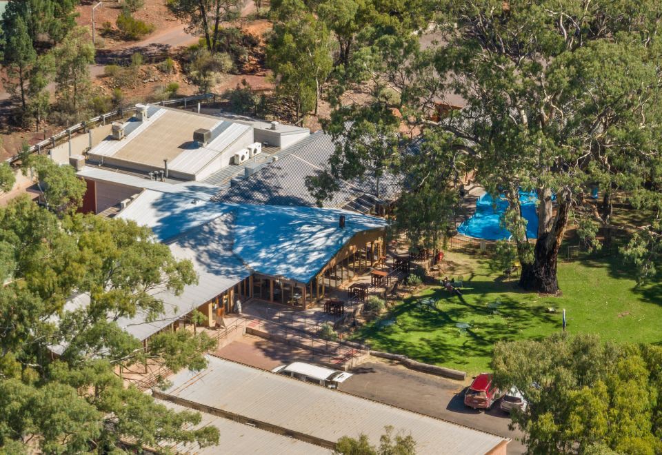 a bird 's eye view of a building with a large tree and a swimming pool at Discovery Resorts - Wilpena Pound