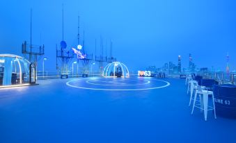 In front of a city at night with illuminated lights, there is a pool at Crowne Plaza Guangzhou City Centre