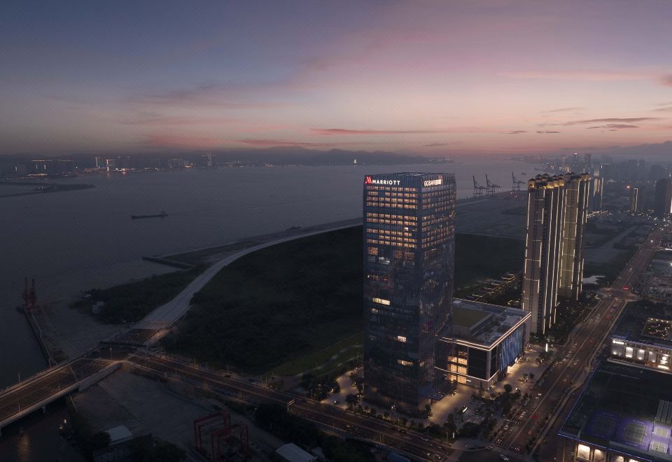 At night, a city skyline with illuminated buildings in the foreground at Shantou Marriott Hotel