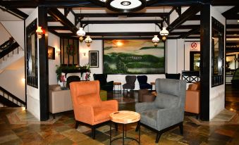 a modern living room with various furniture , including couches , chairs , and a coffee table , arranged around a central area at Strawberry Park Resort