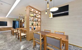 The dining room of the restaurant is modern and furnished with tables and chairs at X Hotel Taikoo Riaduo, Sanlitun, Beijing