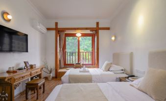 a modern hotel room with two beds , a desk , and a window offering a view of the outdoors at Riverview Hotel