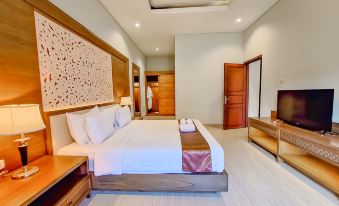 a large bed with white linens is in a room with wooden furniture and a red door at Sekuro Village Beach Resort