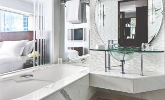The bathroom features white marble walls, a large mirror, and a bathtub adjacent to two sinks at Cordis, Hong Kong