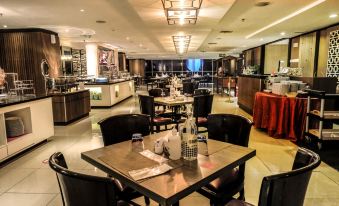 a dining room with a table set for a meal , complete with plates , cups , and utensils at Best Western Premier la Grande Hotel