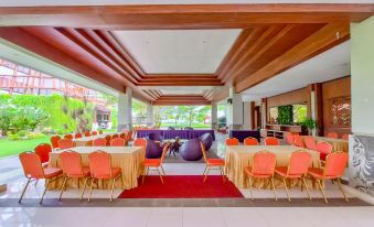 a large dining room with multiple tables and chairs arranged for a party or event at Sekuro Village Beach Resort