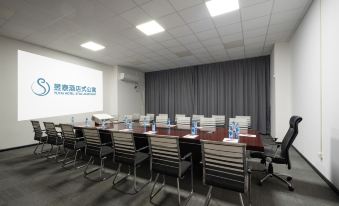 A conference room is equipped with a large table and chairs, arranged for events or social gatherings at Yutai Hotel Apartment (Dongmen Pedestrian Street Luohu Port Branch)