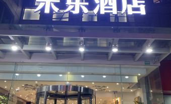 "The entrance to a hotel at night is adorned with a sign that says ""welcome,"" creating a warm and inviting atmosphere" at Motai Hotel (Shanghai Hongqiao International Exhibition Center Jiuxing)