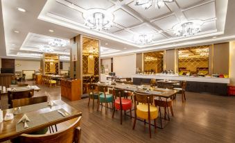 The restaurant features tables and chairs in its central area, as well as in other dining rooms at Shanghai Shaanxi Business Hotel