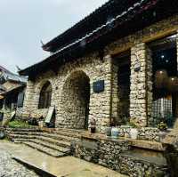 Quaint stone village under Yulong Mountains