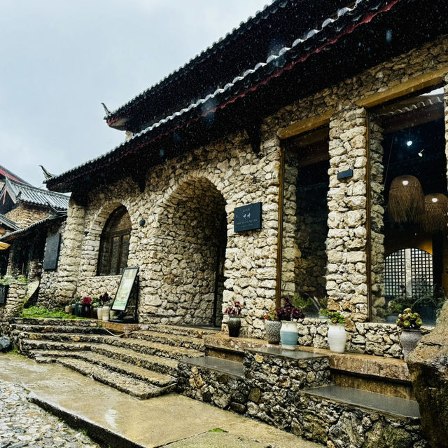 Quaint stone village under Yulong Mountains