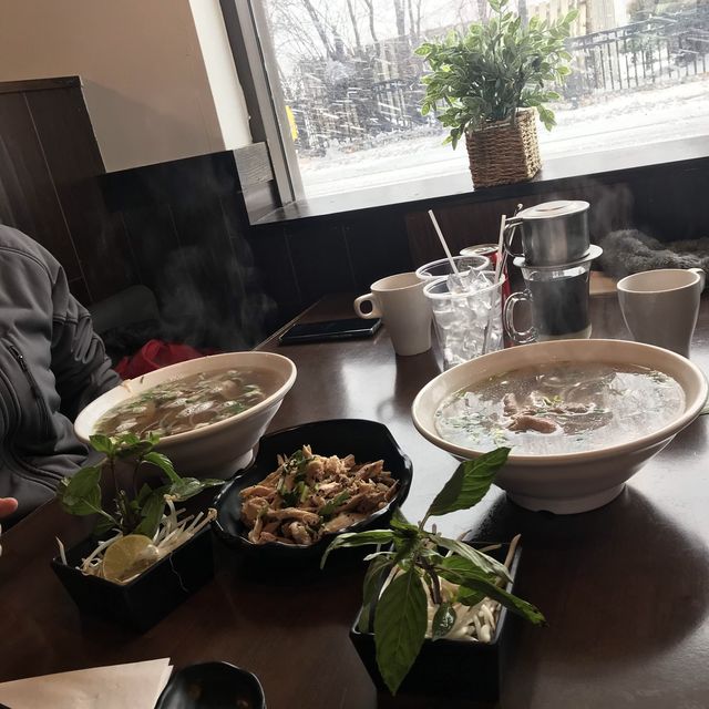 Hot pho (Vietnamese noodles soup) in a cold snowy day