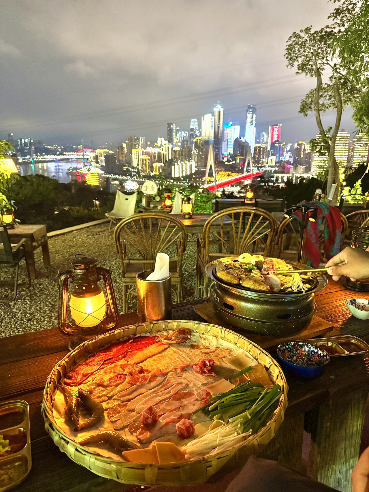 Nanshan is a mountainous area located in the southeast of Chongqing, featuring traditional tea houses and BBQ zones with clear views of the city.

• Highlights of the tea zone: Tea houses are lined along the hillside, serving green tea, oolong tea, and black tea with hot water refills, allowing for extended stays.
• BBQ zone: Located at 南山烧烤一条街 (Nanshan BBQ Street), it offers Chongqing-style BBQ with tables that provide a nighttime city view.
• Commonly found establishments:
  - 南山泉水茶馆 (Nanshan Spring Tea House)
  - 一棵树观景区 (Yikeshu Scenic Area) restaurant zone
  - BBQ restaurants along the hillside in the BBQ Street zone
• Views: The Chongqing cityscape, rivers, and high-rise buildings in the downtown area (中心城区).

Many establishments combine tea-drinking and BBQ dining in one place, allowing visitors to relax for extended periods. This makes it a favorite spot for locals to unwind after work or enjoy an evening date.

📍 Location:
南山风景区 (Nanshan Scenic Area), 南岸区 (Nan’an District), Chongqing.