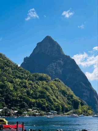#winterescape ☀️ Discover Soufrière View Point: Where Peaks Meet Paradise! Tucked away in Belle Vue, Saint Lucia, this breathtaking lookout blends mountain majesty and tranquil blue waters—ideal for sun-chasers and nature lovers. 🚤🏞️

Start your adventure by arriving early when the skies are clear, and the sailboats gently bob below the mountain. Follow the main road up to RWXQ+9G, Belle Vue, and let each bend reveal bigger views. Must-do: Walk along the edge of the viewpoint and take in the panoramic sweep of Soufrière’s dramatic peaks, shimmering sea, and lush greenery. Snap insta-worthy shots right as the sun hits the mountain peak—your image of sailboats at rest makes for a classic “Saint Lucia postcard moment.” If you’re a nature enthusiast, pause and listen for local bird calls or spot unique Caribbean trees.

Practical tip: There aren’t many shops or water points nearby, so pack hydration and a light snack. Sunscreen and hats are essentials—the sun is strong even on breezy days. If the weather shifts, you’ll spot the sailboats retreating: a signal to head down before quick showers roll in.

Safety note: The viewpoint sits close to steep drops—stay behind fences, especially if taking photos. Weekdays offer quieter visits; weekends can get busier with local families.

#Soufriere #SaintLucia #NatureVision #MountainViews #CaribbeanTravel