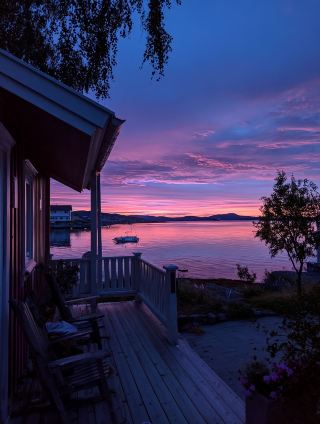 Norwegian fjord wonderland with a whole range of snowy mountains, the sunset is just too romantic!