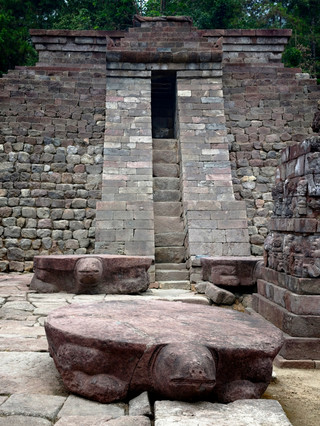 Explore the primitive stone ruins of Candi Sukuh, resembling Mayan pyramids