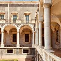 A Solo Traveller’s Retreat: Benedictine Monastery of San Nicolò l’Arena** 🏰