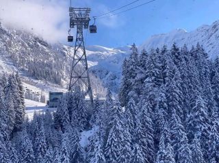 Winter cable car trip rising over the white snowy landscape