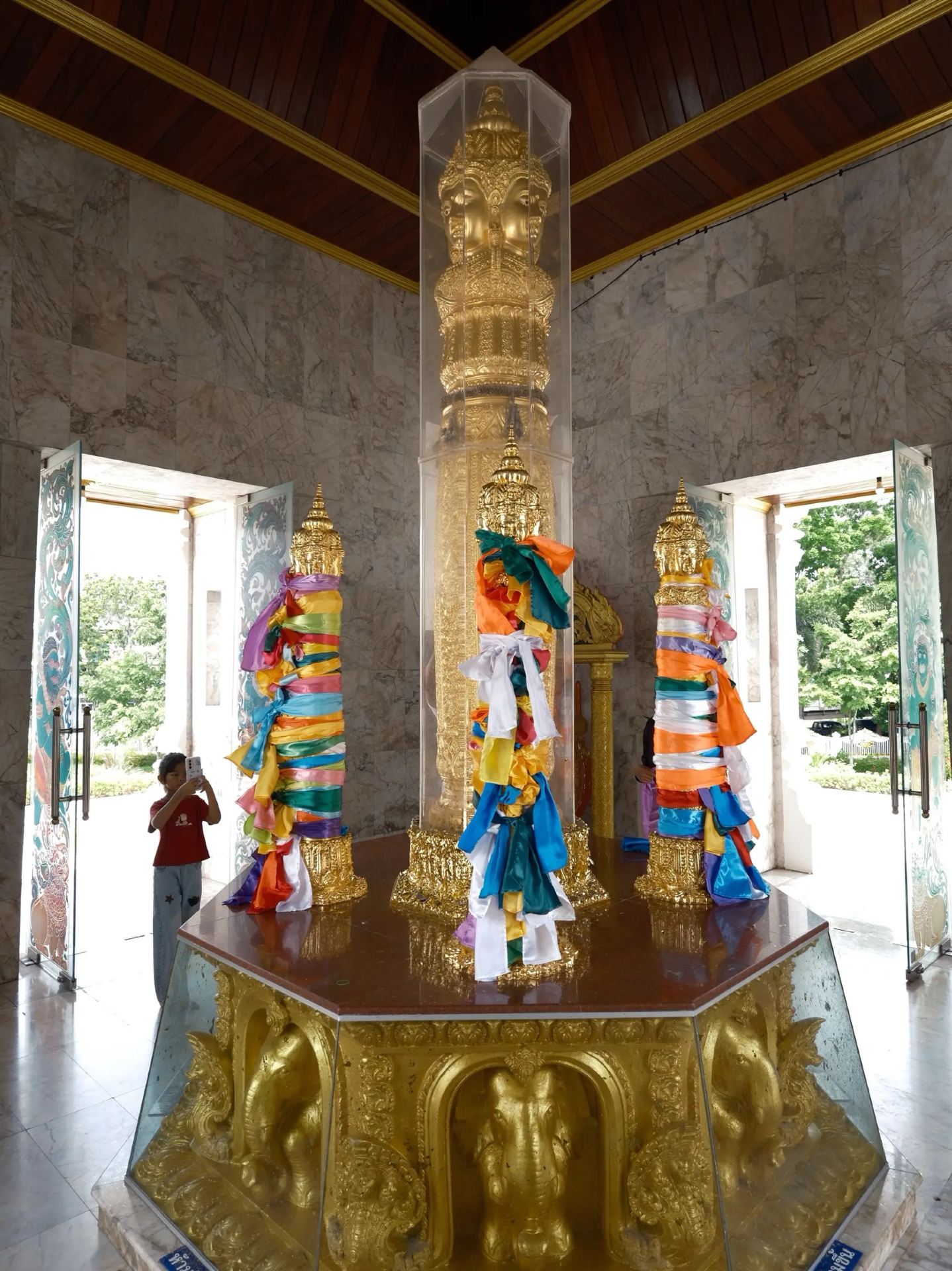 The Surat Thani City Pillar Shrine features a uniquely carved city pillar.